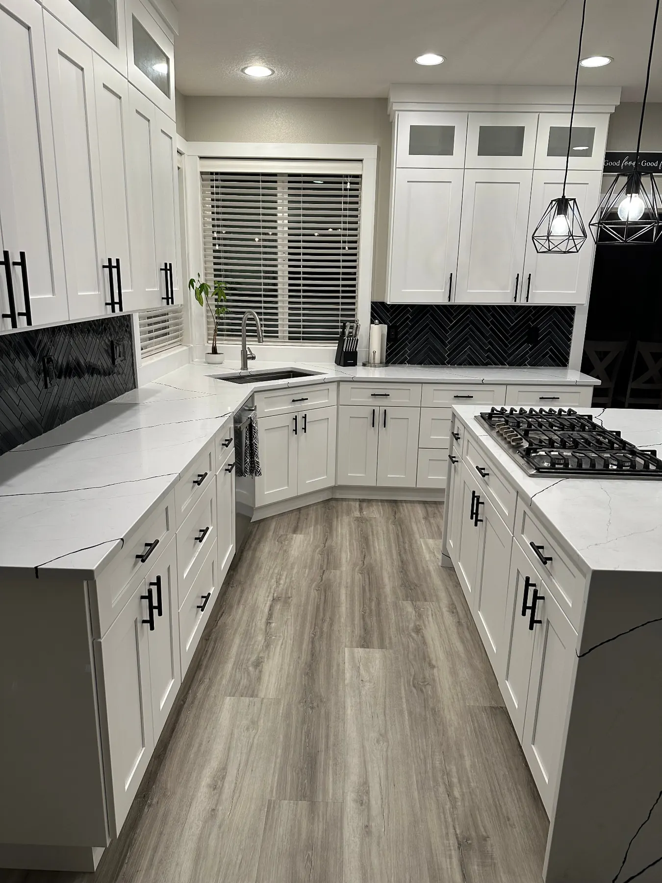 White kitchen with gas cooktop island and matte black hardware